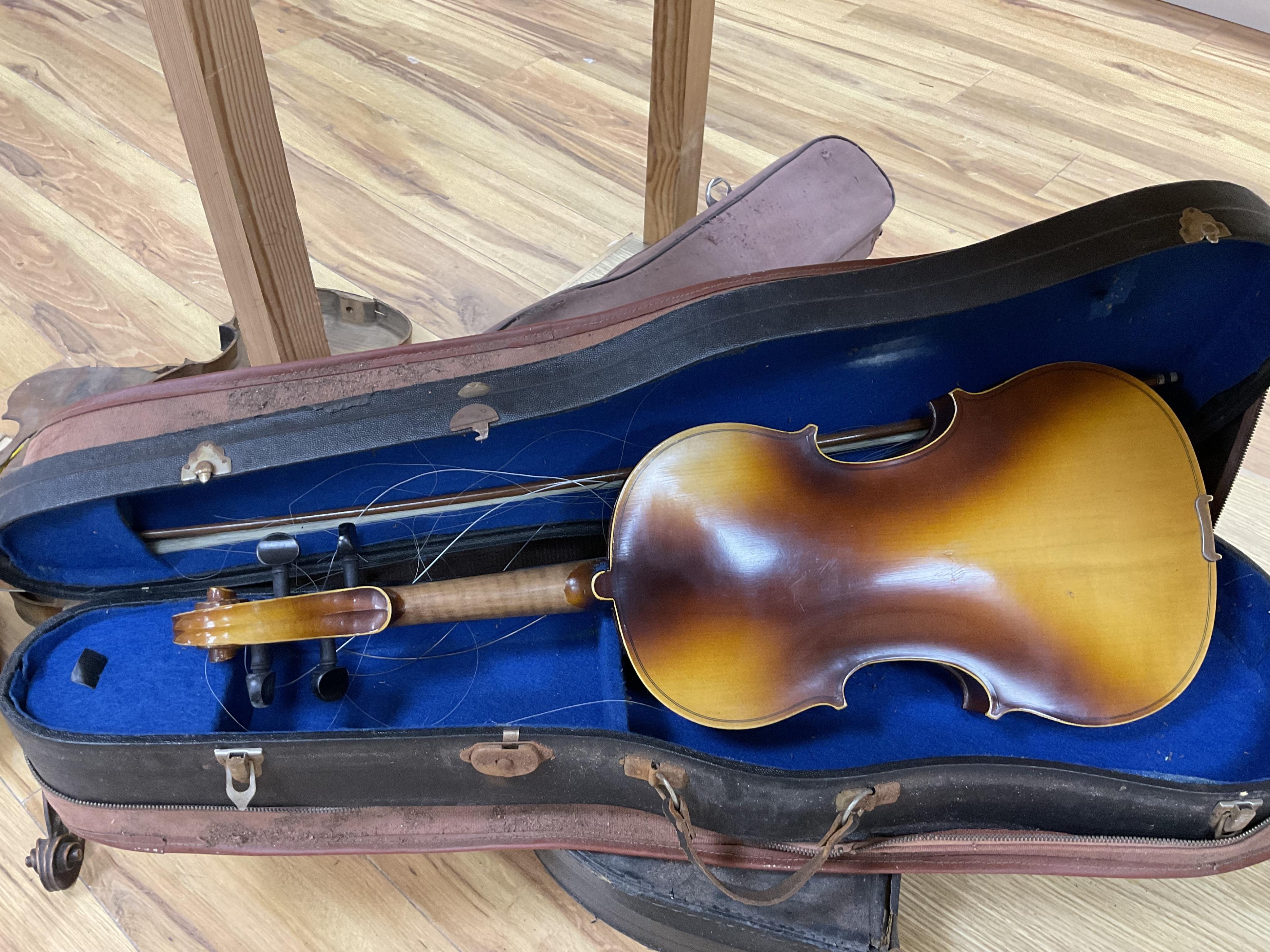 A quantity of violin parts and violins, a ukelele, a double bass scroll, a pinfold metronome, a violin case by Hill, a viola etc. Condition - for restoration